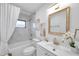 Elegant bathroom with marble tile and gold fixtures at 1707 Tahoe Dr, Sun City Center, FL 33573