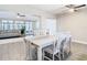 Dining area with white table and chairs, and view to living room and back yard at 1707 Tahoe Dr, Sun City Center, FL 33573