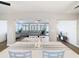 Bright dining room with white table and chairs, view into living room at 1707 Tahoe Dr, Sun City Center, FL 33573