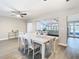 Open concept dining room with white table and chairs, overlooking living room at 1707 Tahoe Dr, Sun City Center, FL 33573