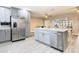 Updated kitchen featuring an island, stainless steel appliances, and gray cabinetry at 1707 Tahoe Dr, Sun City Center, FL 33573