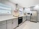 Modern kitchen with gray cabinets, white subway tile, and stainless steel appliances at 1707 Tahoe Dr, Sun City Center, FL 33573