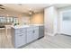 Modern kitchen with gray cabinets, quartz countertops, and stainless steel appliances at 1707 Tahoe Dr, Sun City Center, FL 33573