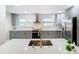 Modern kitchen with gray cabinets, white subway tile backsplash and stainless steel appliances at 1707 Tahoe Dr, Sun City Center, FL 33573