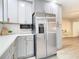 Stainless steel refrigerator in a newly remodeled kitchen with gray cabinets at 1707 Tahoe Dr, Sun City Center, FL 33573