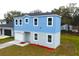 Two-story light blue house, white garage, and small yard at 3708 Wiggins Leaf St, Tampa, FL 33619