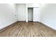 Spacious bedroom with wood-look flooring and a large closet at 3708 Wiggins Leaf St, Tampa, FL 33619