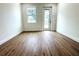 Bright bedroom with wood-look flooring and access to the backyard at 3708 Wiggins Leaf St, Tampa, FL 33619