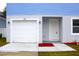 White garage door and light-colored front door with landscaping at 3708 Wiggins Leaf St, Tampa, FL 33619