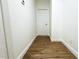 Clean hallway with wood-look flooring and white walls at 3708 Wiggins Leaf St, Tampa, FL 33619