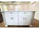 White kitchen island with quartz countertop and ample storage at 3708 Wiggins Leaf St, Tampa, FL 33619