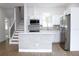 Modern kitchen with white cabinets, stainless steel appliances, and island at 3708 Wiggins Leaf St, Tampa, FL 33619