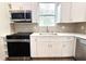Modern kitchen features white shaker cabinets, stainless steel appliances, and quartz countertops at 3708 Wiggins Leaf St, Tampa, FL 33619