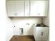 Bright laundry room with white cabinets and a utility sink at 3708 Wiggins Leaf St, Tampa, FL 33619