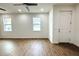 Spacious living room with wood-look flooring and plenty of natural light at 3708 Wiggins Leaf St, Tampa, FL 33619