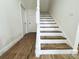 Modern staircase with wood treads and white risers at 3708 Wiggins Leaf St, Tampa, FL 33619
