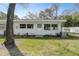 White building exterior with a grassy yard at 11200 102Nd Ave # 61, Seminole, FL 33778