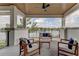 Relaxing balcony overlooking the lake with wooden furniture at 9586 Troutwater Ln, Tampa, FL 33618