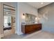 Vanity with floating wooden cabinets and modern light fixtures at 9586 Troutwater Ln, Tampa, FL 33618