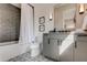 Clean bathroom with grey tile, modern vanity, and patterned floor at 9586 Troutwater Ln, Tampa, FL 33618