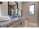 Modern bathroom with granite countertop, wooden cabinets, and a large mirror at 9586 Troutwater Ln, Tampa, FL 33618