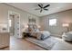 Spacious bedroom with hardwood floors, a comfy bed and plenty of light at 9586 Troutwater Ln, Tampa, FL 33618