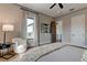 Light-filled bedroom with large window, comfy chair and ceiling fan at 9586 Troutwater Ln, Tampa, FL 33618