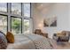 Bedroom with lake view, featuring a plush bed and sitting area at 9586 Troutwater Ln, Tampa, FL 33618
