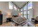 Main bedroom with lake view, featuring a plush bed and sitting area at 9586 Troutwater Ln, Tampa, FL 33618