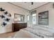 Bright bedroom with large window, dresser, and artwork at 9586 Troutwater Ln, Tampa, FL 33618