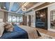Elegant Primary bedroom featuring a stunning fireplace and large windows at 9586 Troutwater Ln, Tampa, FL 33618