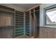 Bright walk-in closet with window, shelves, and hanging space at 9586 Troutwater Ln, Tampa, FL 33618