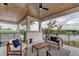 Relaxing covered patio overlooking a lake with comfortable seating at 9586 Troutwater Ln, Tampa, FL 33618