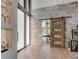 Modern entryway, showcasing a sliding barn door and stone wall at 9586 Troutwater Ln, Tampa, FL 33618