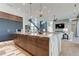 Open concept kitchen with large island and breakfast bar, overlooking living area at 9586 Troutwater Ln, Tampa, FL 33618