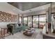 Relaxing living room featuring a green sofa and large wood wall art at 9586 Troutwater Ln, Tampa, FL 33618