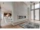 Open living area showcasing a linear fireplace and hardwood floors at 9586 Troutwater Ln, Tampa, FL 33618