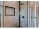 Modern shower with hexagonal tile and frameless glass enclosure at 9586 Troutwater Ln, Tampa, FL 33618