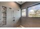 Walk-in shower with multiple shower heads and a built-in shelf at 9586 Troutwater Ln, Tampa, FL 33618