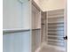 Spacious walk-in closet with ample shelving and hanging rods at 9586 Troutwater Ln, Tampa, FL 33618