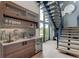 Modern wet bar with wooden cabinetry and a beverage fridge at 9586 Troutwater Ln, Tampa, FL 33618