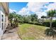 Spacious backyard with a grassy area and tropical plants at 1032 Radison Ave # 2, Sun City Center, FL 33573