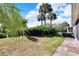 Landscaped backyard with palm trees at 1032 Radison Ave # 2, Sun City Center, FL 33573