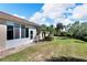 Large backyard with grassy area and tropical plants at 1032 Radison Ave # 2, Sun City Center, FL 33573