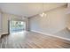 Bright dining area with wood-look floors and sliding glass doors to a patio at 1032 Radison Ave # 2, Sun City Center, FL 33573