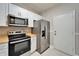 Stainless steel appliances and butcher block countertops in this updated kitchen at 1032 Radison Ave # 2, Sun City Center, FL 33573