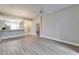 Light-filled living room with wood-look floors and ceiling fan at 1032 Radison Ave # 2, Sun City Center, FL 33573