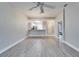 Open concept living room with kitchen and wood-look floors at 1032 Radison Ave # 2, Sun City Center, FL 33573