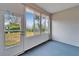 Sunroom with windows, door and blue carpet at 1032 Radison Ave # 2, Sun City Center, FL 33573