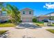 Two-story house with a two-car garage and landscaped front yard at 17035 Peaceful Valley Dr, Wimauma, FL 33598